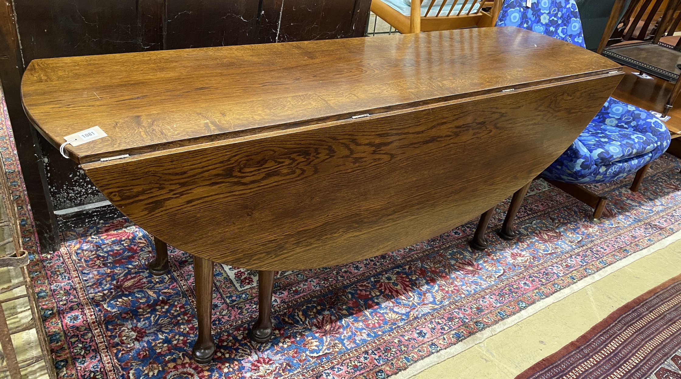 A reproduction 18th century style oak drop leaf wake table, length 196cm, width 153cm extended, height 77cm